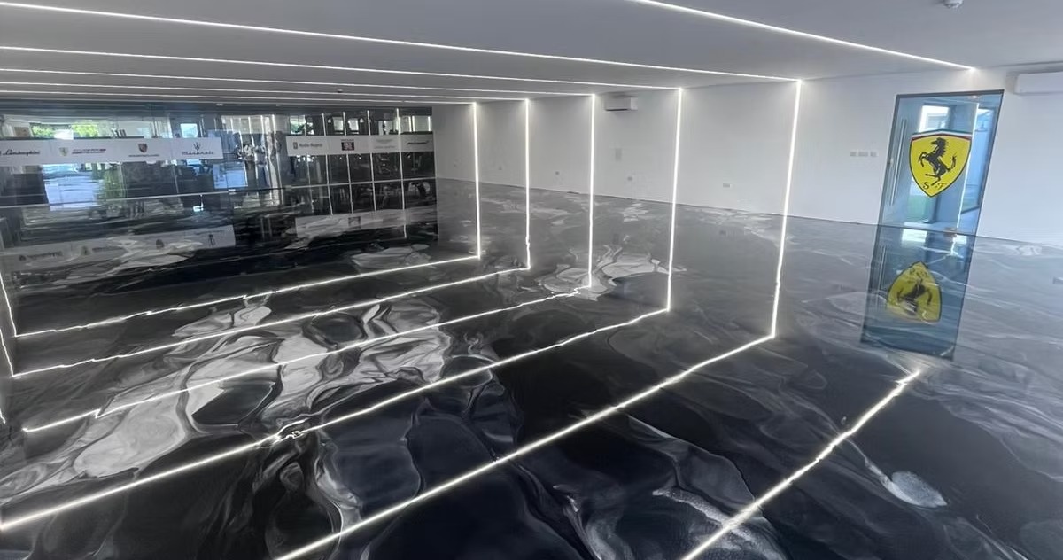 Liquid-gloss metallic epoxy floor reflecting garage lighting